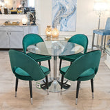Cassidy green dining chairs around a clear glass dining table